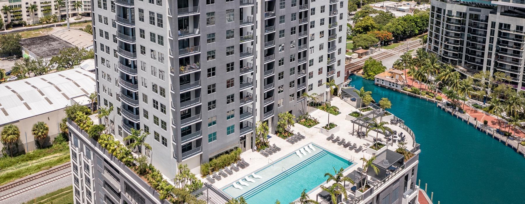a high angle view of a building with a pool and river