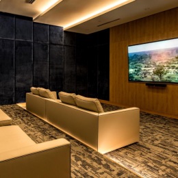 a theater style room with seating and a tv