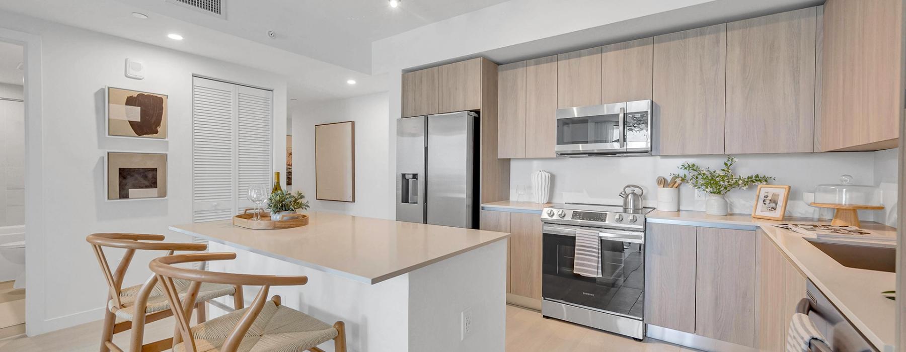 a kitchen with wooden cabinets and stainless steel appliances