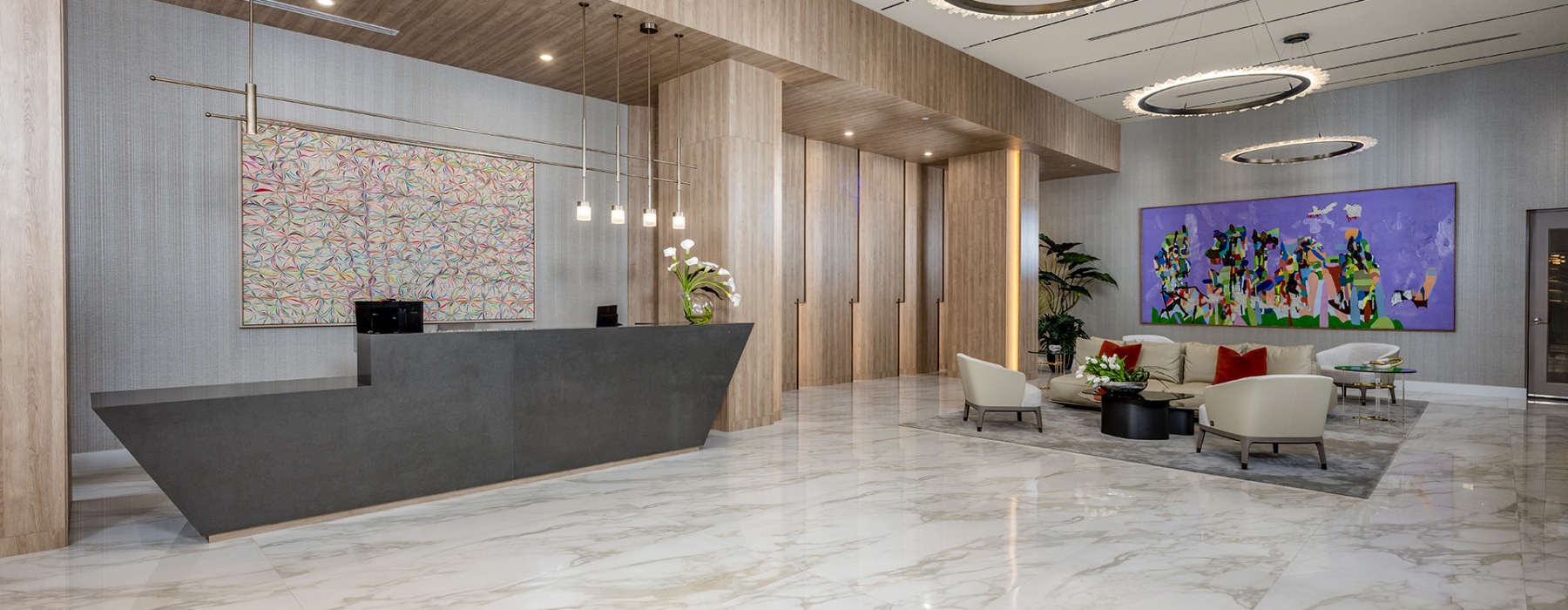 a large room with a reception desk and chandeliers