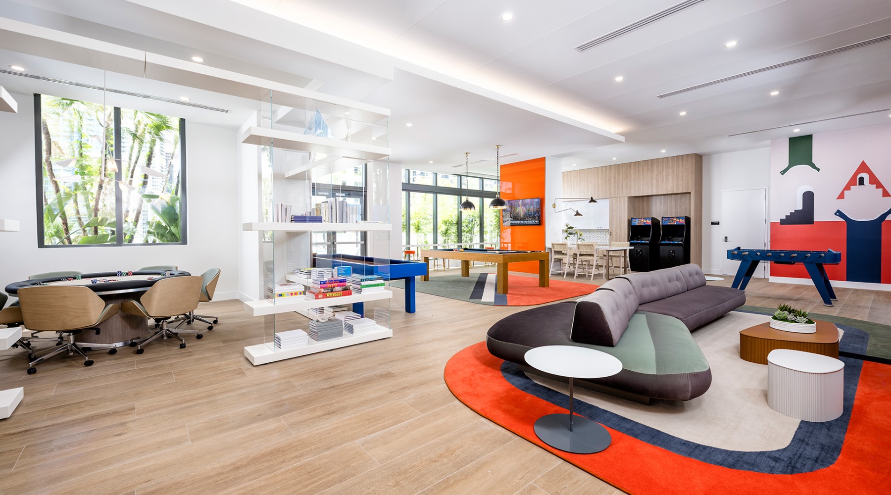a lounge with a large rug seating tv and pool table