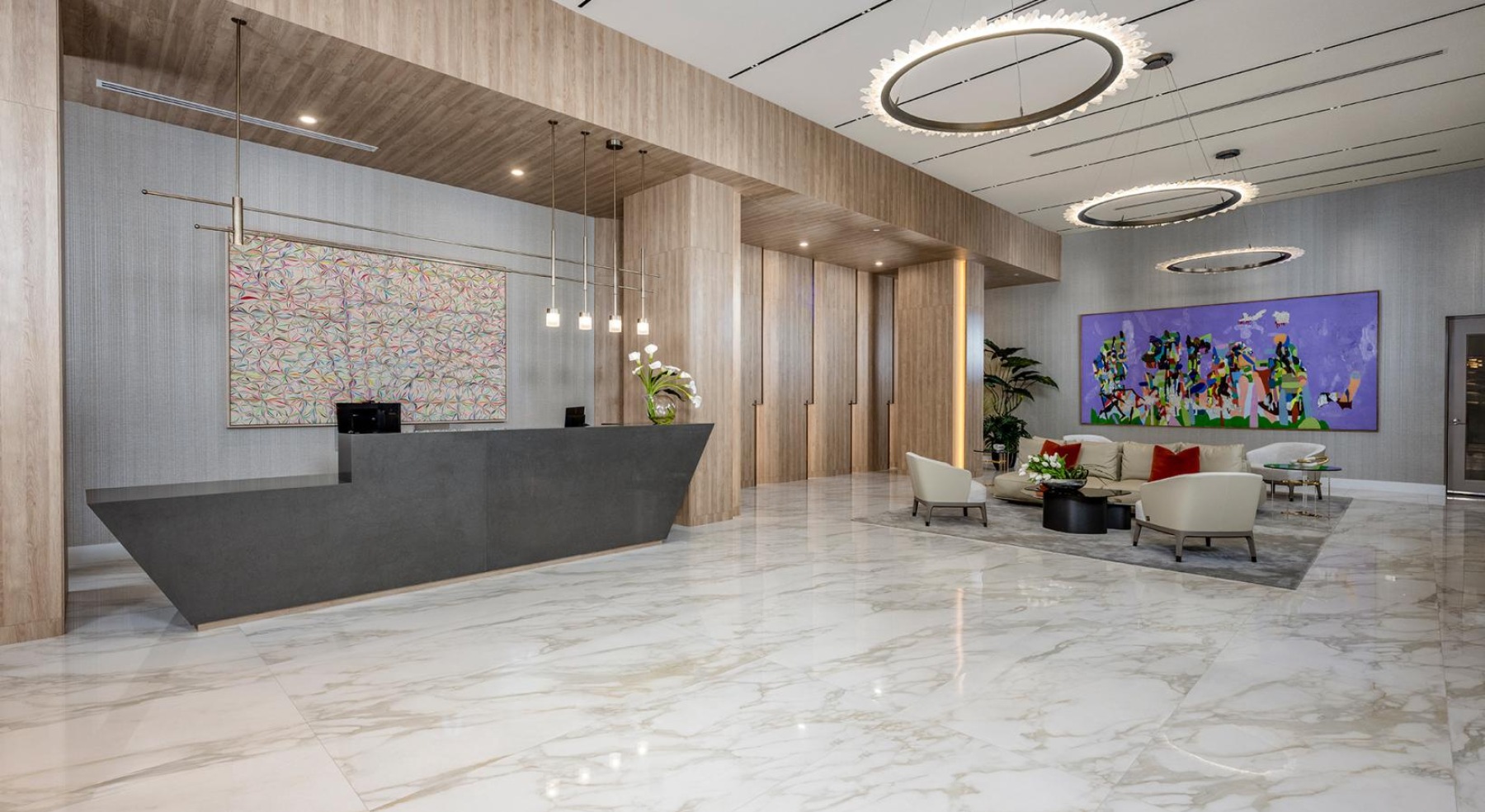 a large room with a reception desk and chandeliers